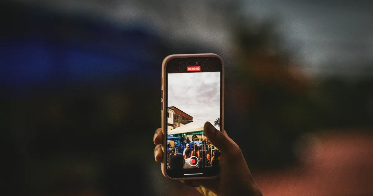 A person taking a photograph with a mobile phone