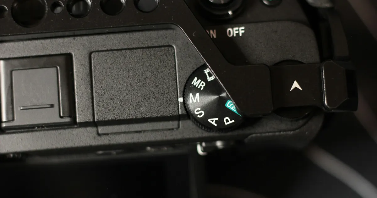 A close-up of a camera mode dial showing exposure settings