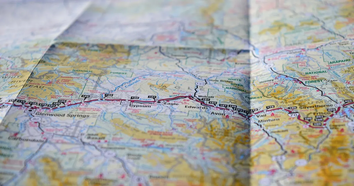 A close-up of a printed map showing roads and place names